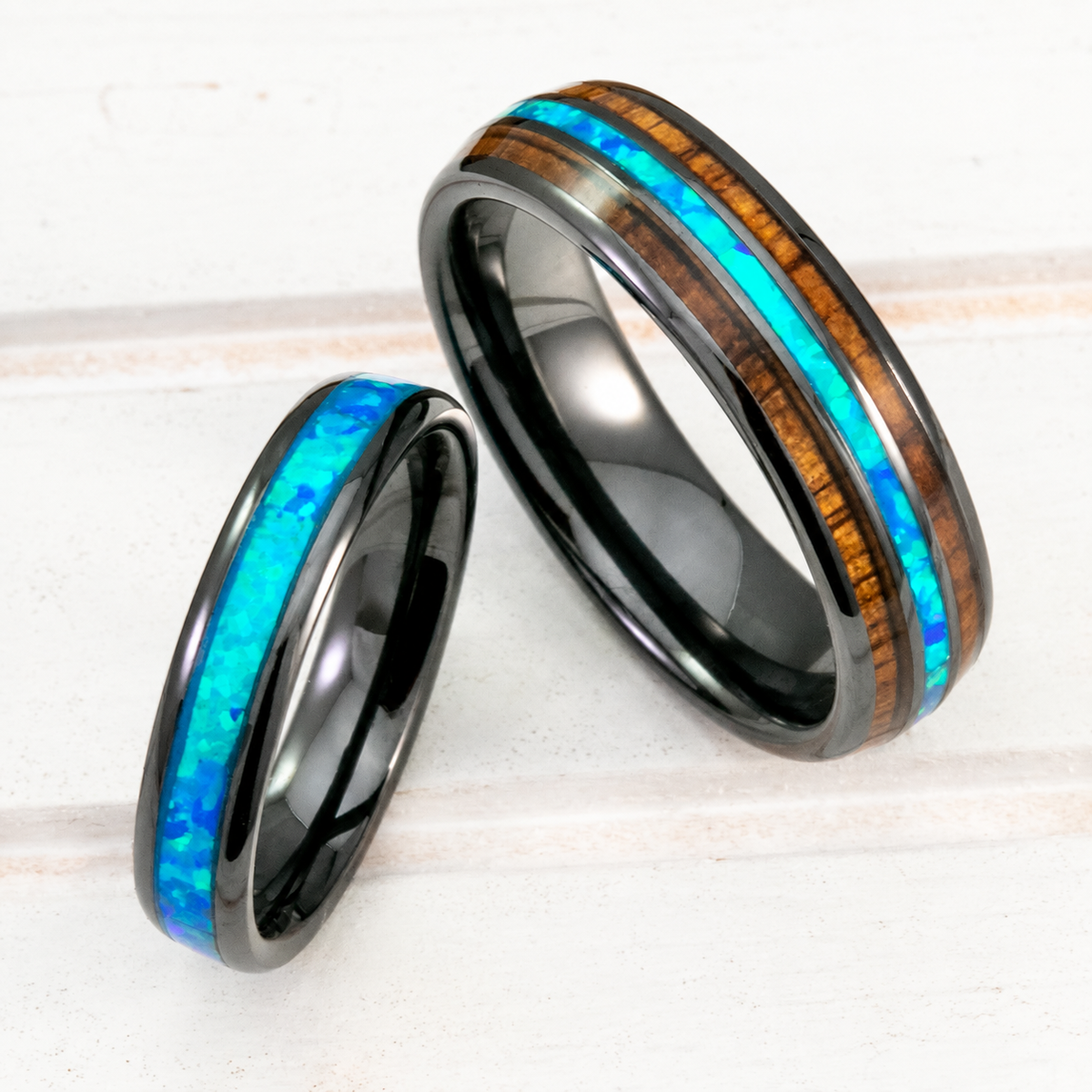Black ceramic ring set with blue opal and Hawaiian koa wood inlays