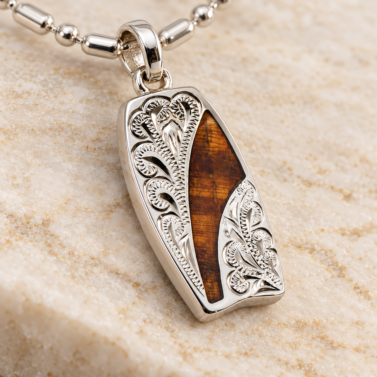 Hand engraved sterling silver body board pendant with koa wood inlay, alternate angle
