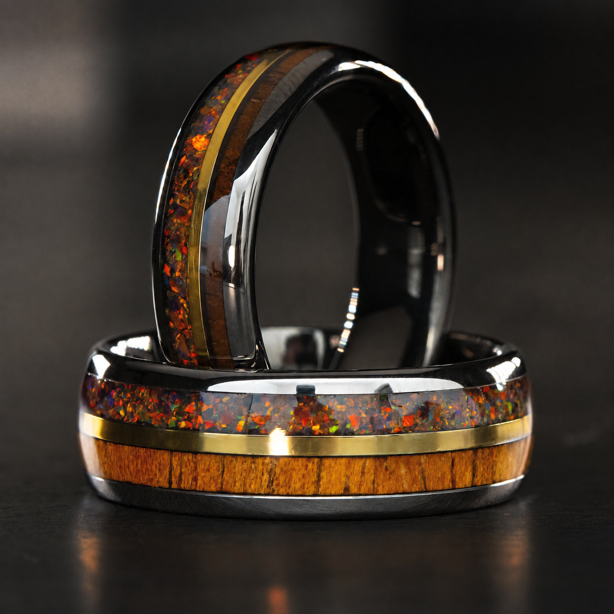 Gunmetal tungsten ring set with fire opal, Hawaiian koa wood, and gold strip inlay