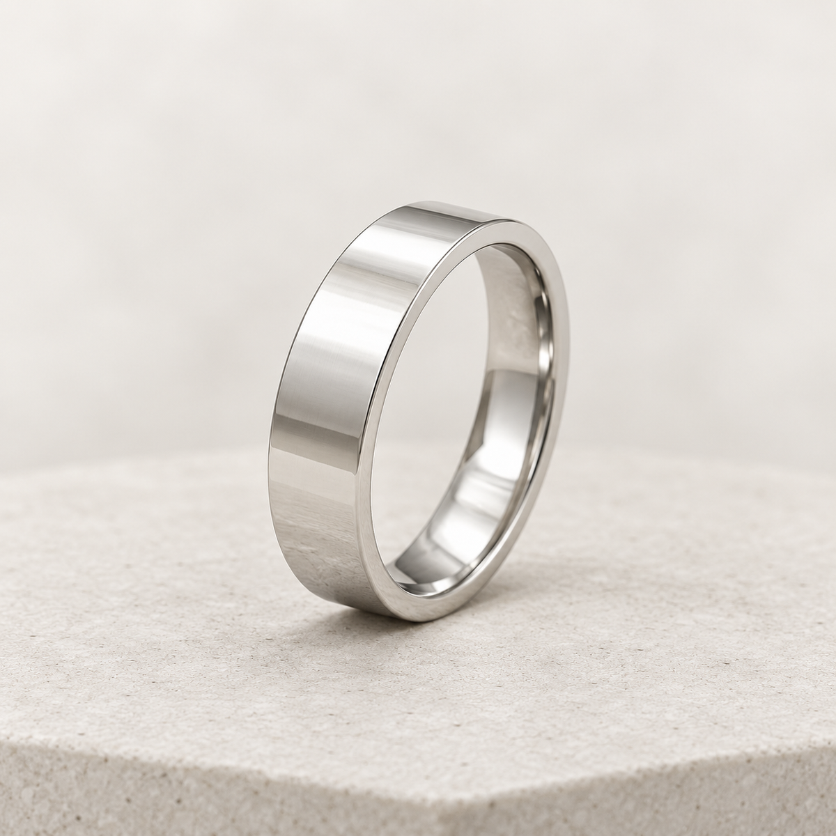 10K white gold 6mm polished wedding band upright on ivory stone
