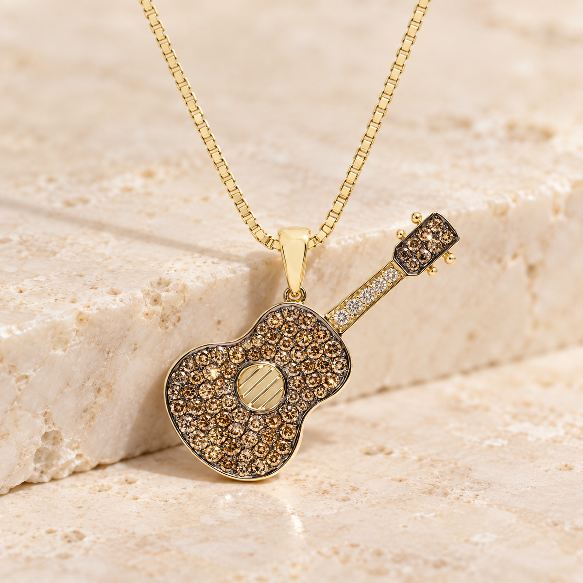 14K yellow gold chocolate diamond guitar pendant on chain against ivory stone