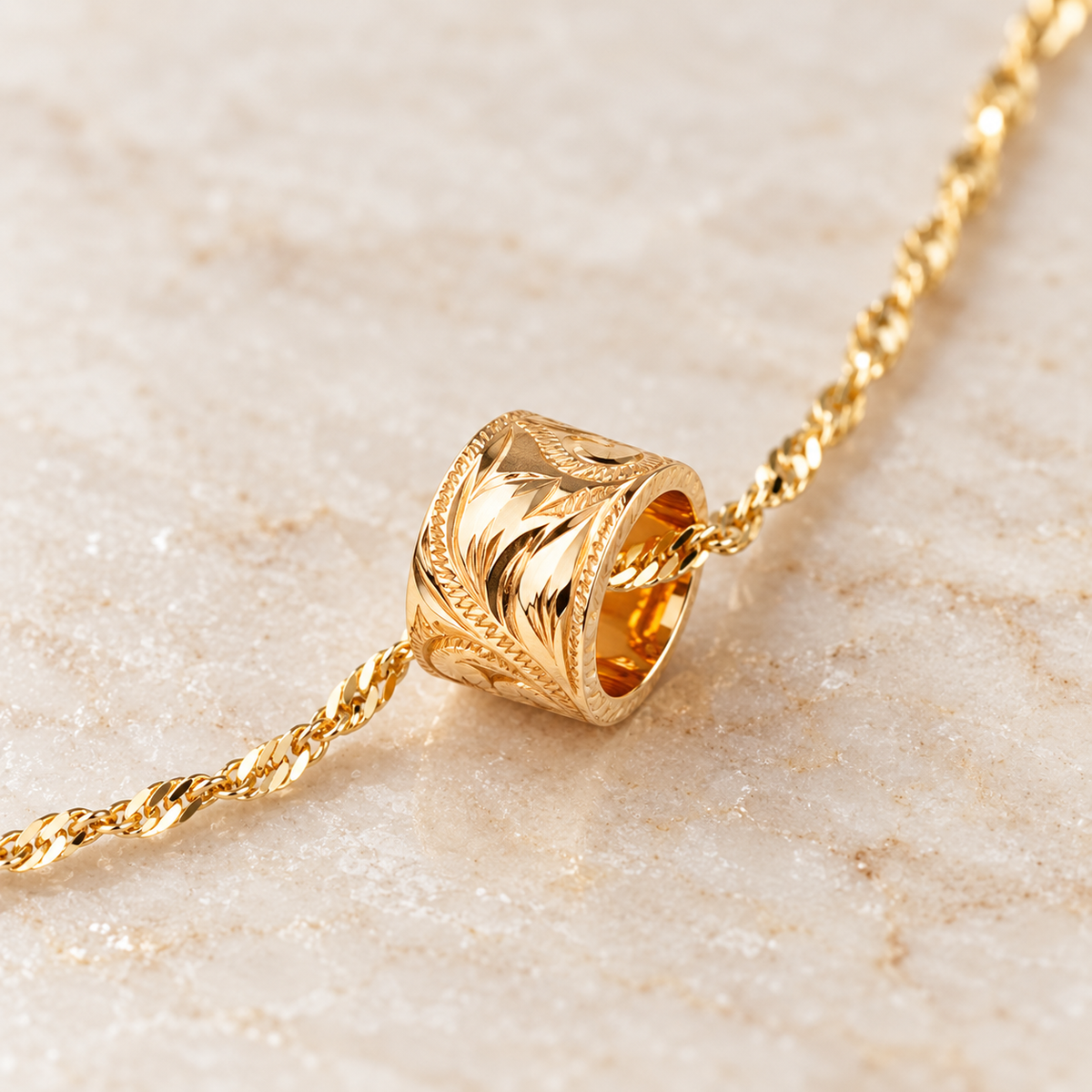 Opposite-end view of Hawaiian hand-engraved 14K gold tube necklace with twist chain