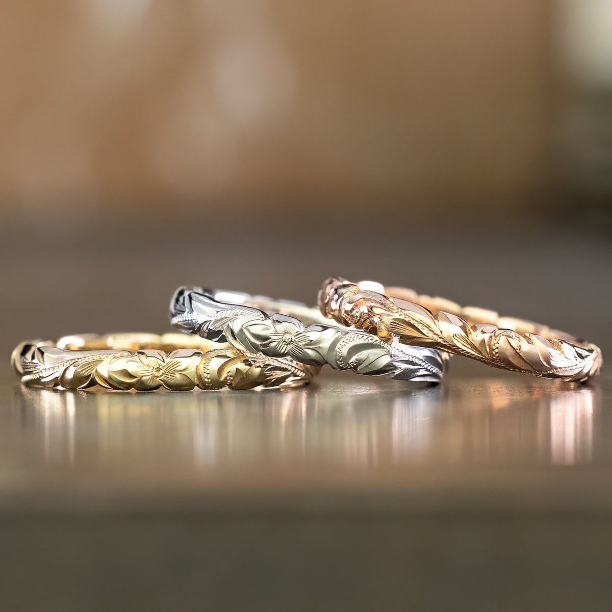 Four slim 3mm Hawaiian wave edge bands in yellow, white and rose gold, lined up