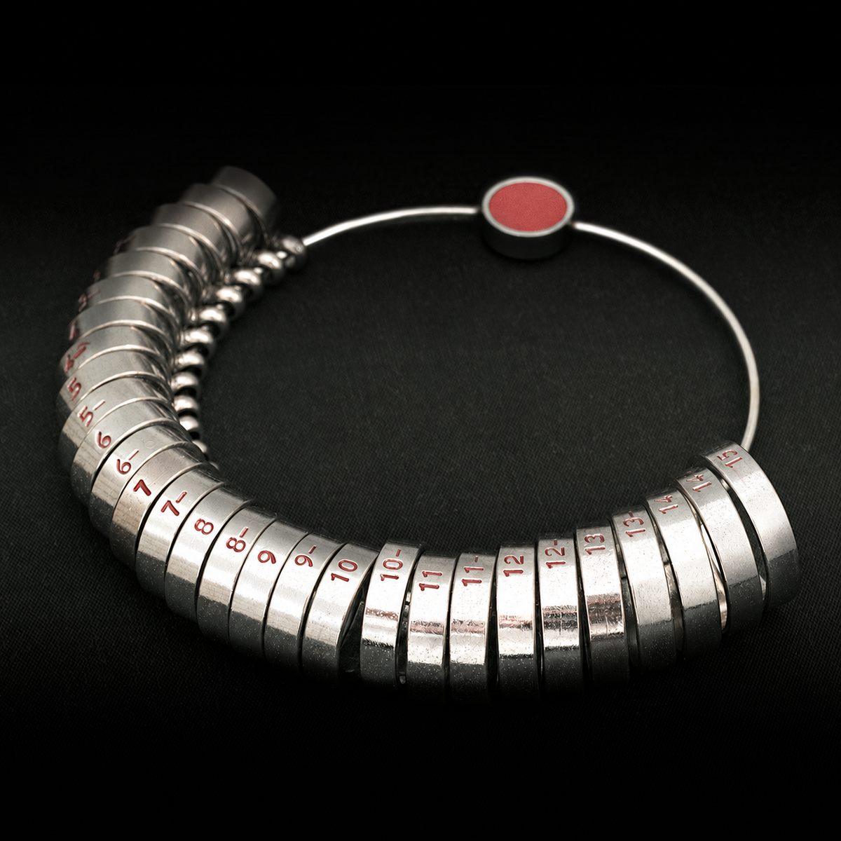 Metal ring sizing gauge with red engraved size markings