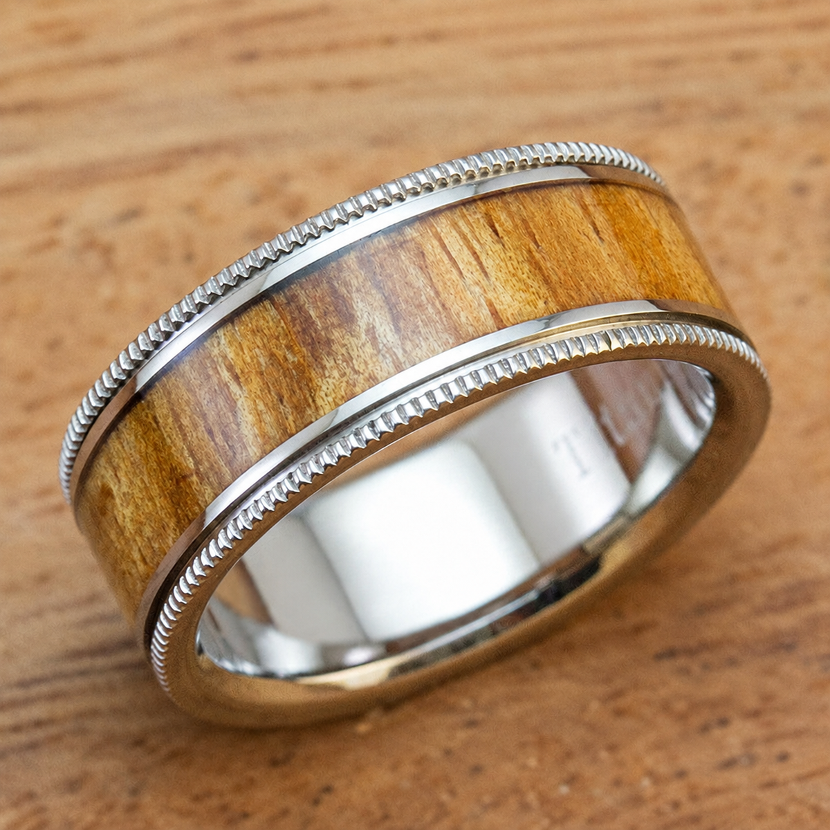 Titanium wedding band with Hawaiian koa wood inlay and detailed edges, clean product image