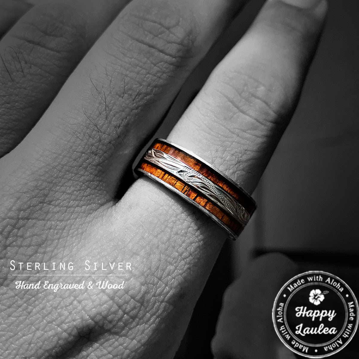 Hand wearing a silver Hawaiian ring with dark koa wood inlay