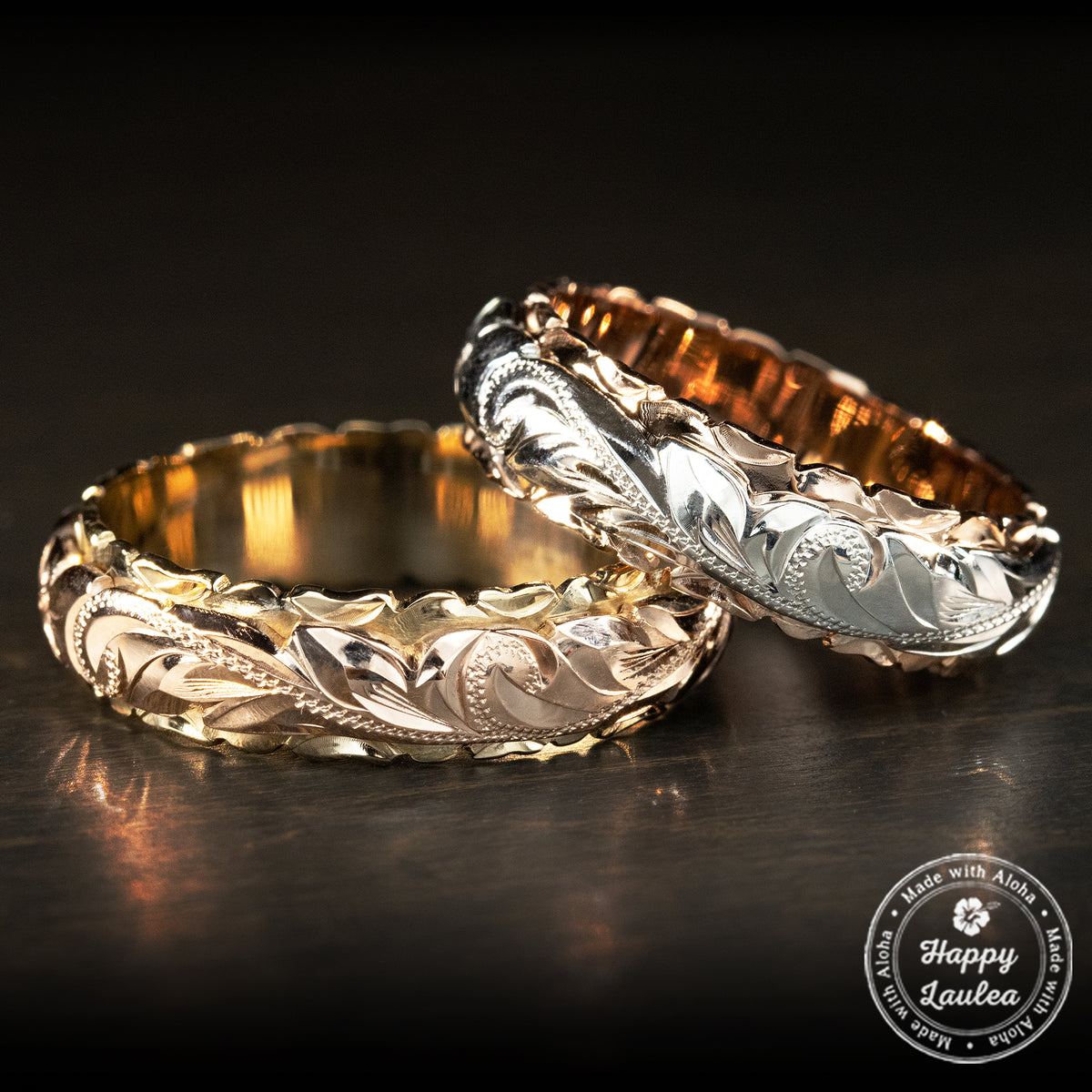 Pair of two tone Hawaiian heritage rings in rose and white gold over yellow gold