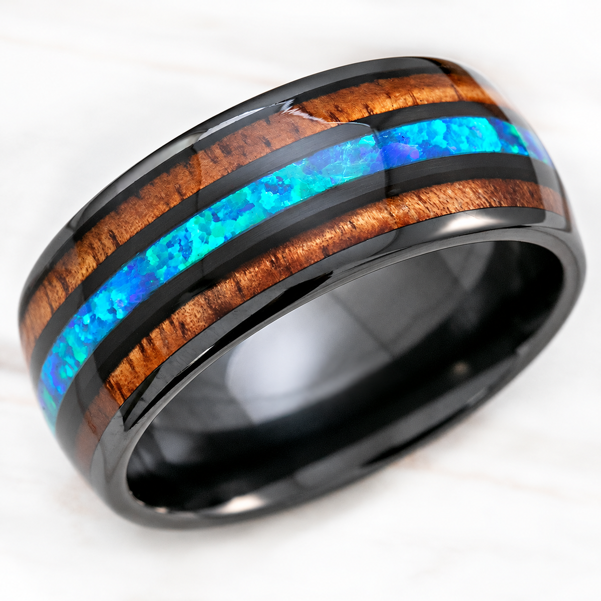 Black ceramic ring with blue opal and koa wood tri-inlay