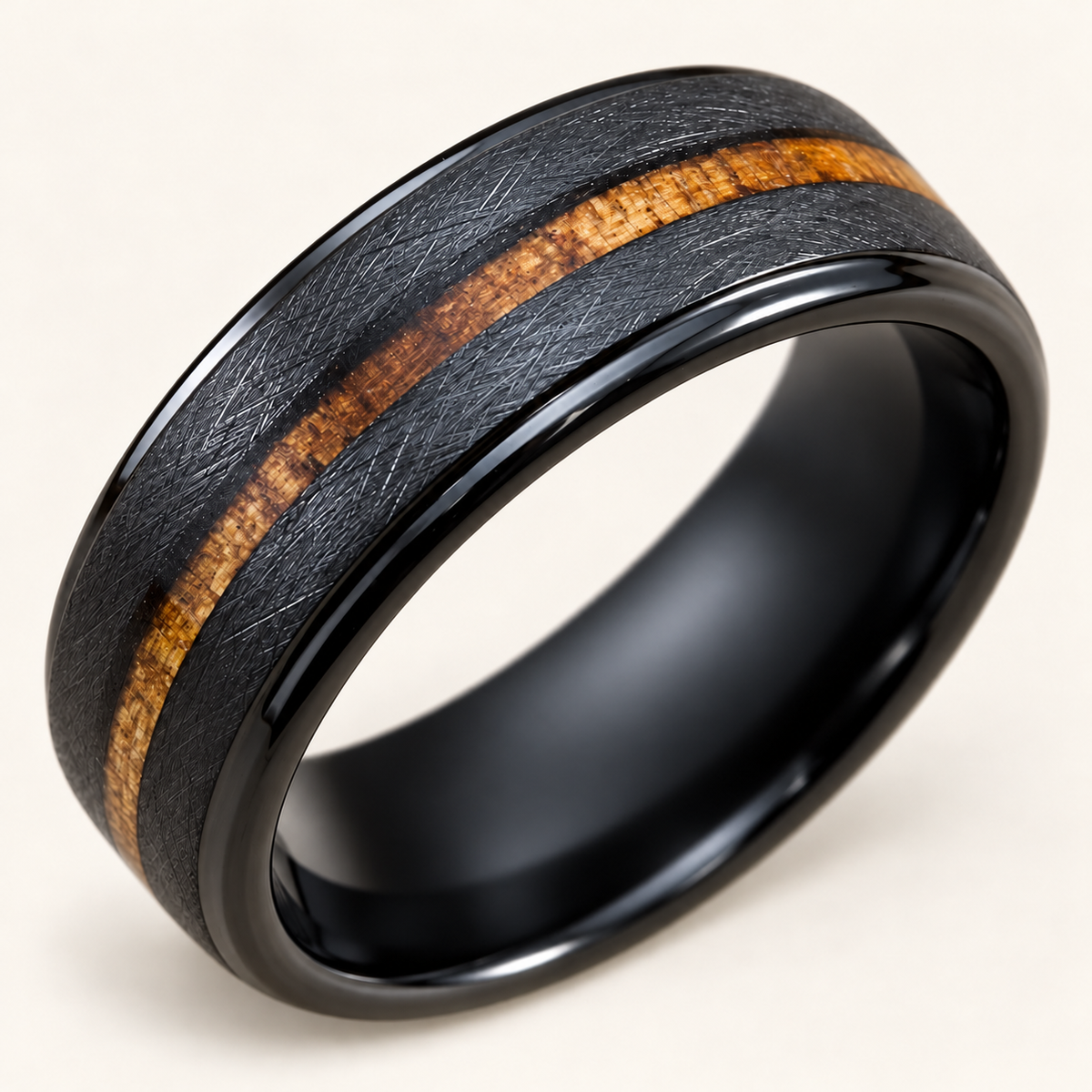 Diagonal view of an 8mm black tungsten koa ring with cross-brushed finish and polished stepped rims on ivory