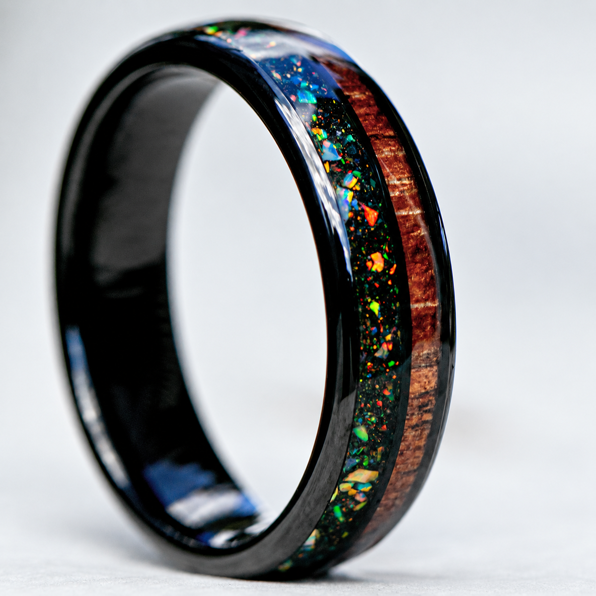 Black tungsten ring with midnight fire opal and Hawaiian koa wood