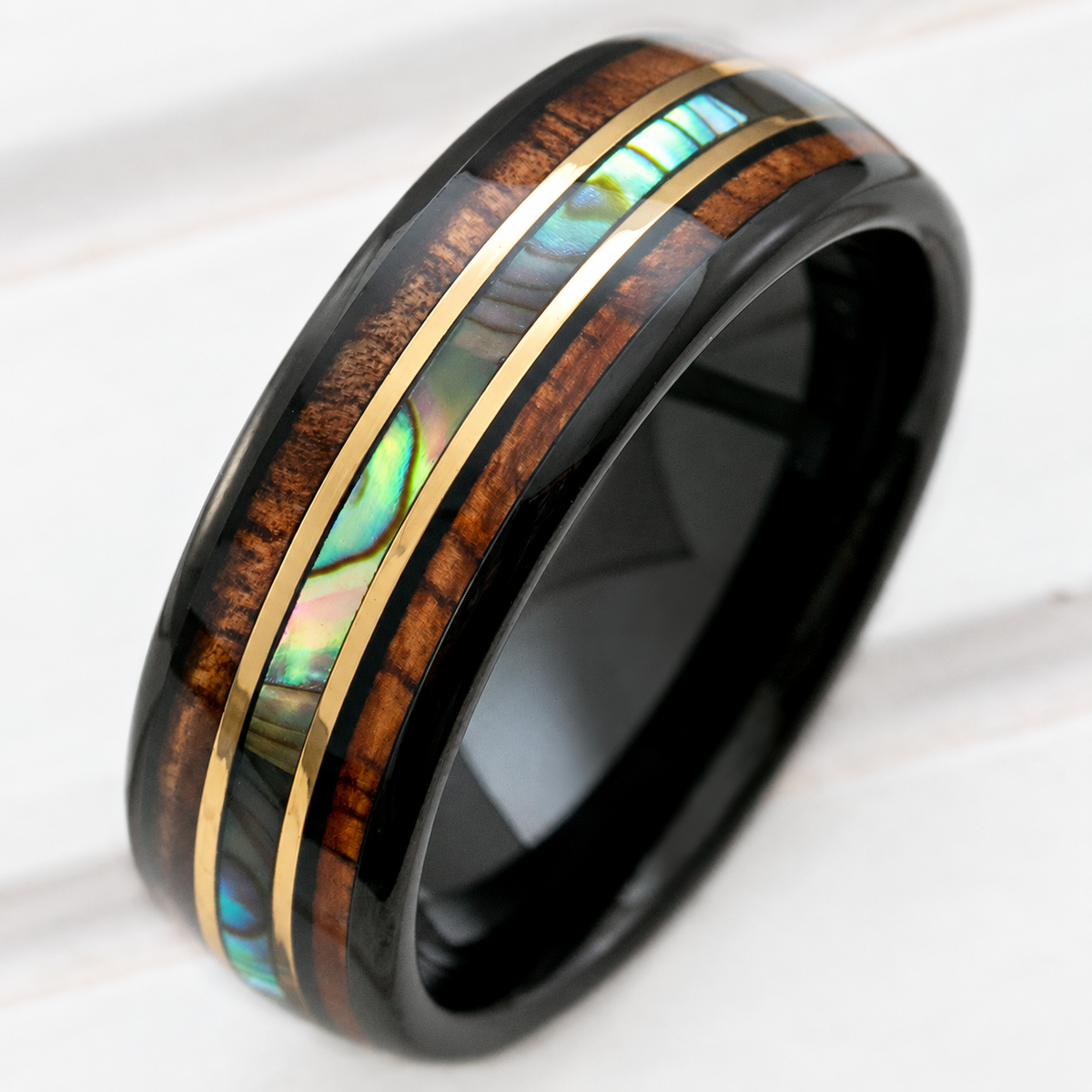 Black tungsten ring with Hawaiian koa wood, abalone shell, and gold strip inlay