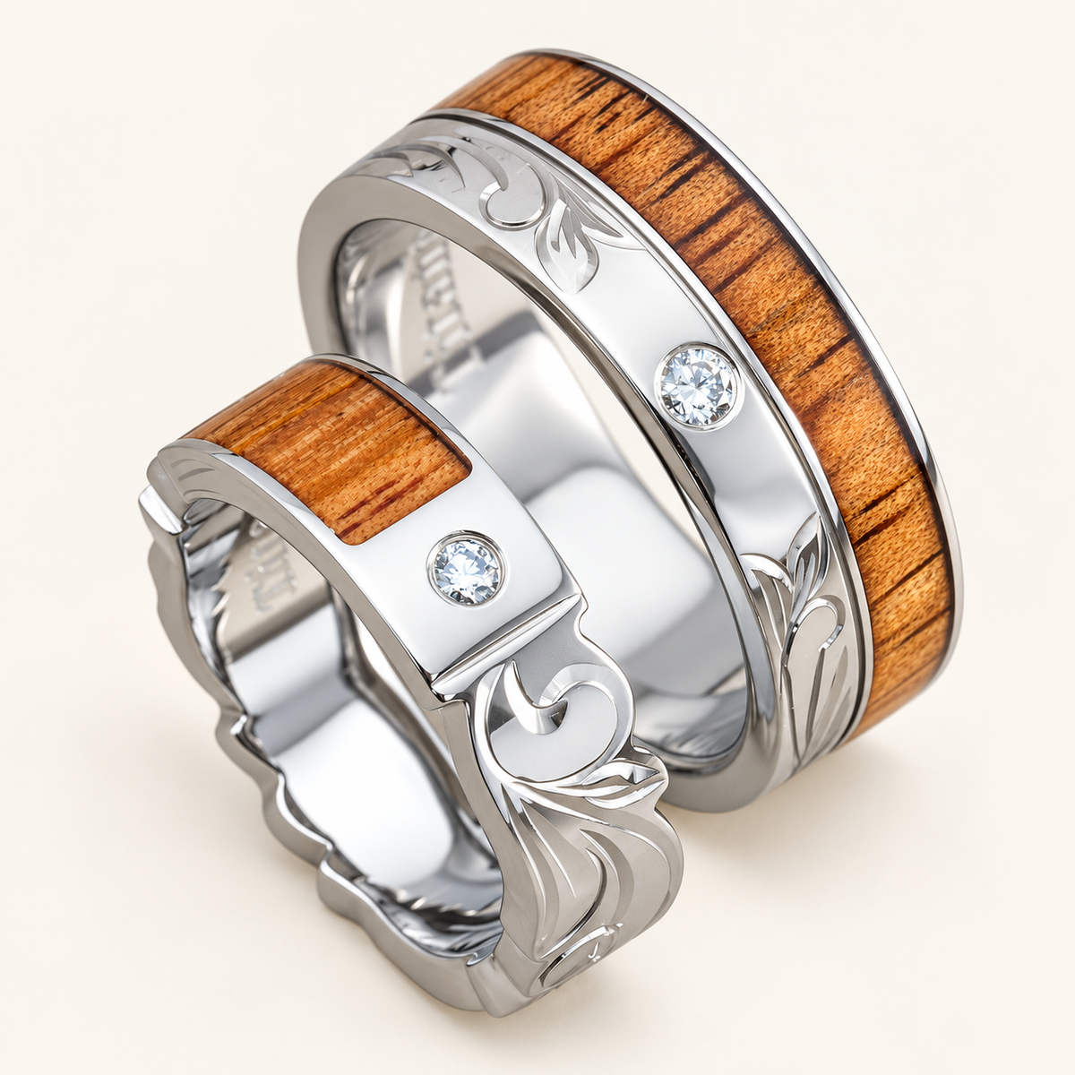 Titanium Hawaiian scroll and leaf ring set with two low-set diamonds and koa wood, front view on ivory