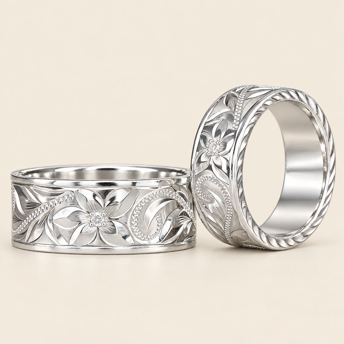 Two sterling silver Hawaiian Old English rings with small center stones on ivory