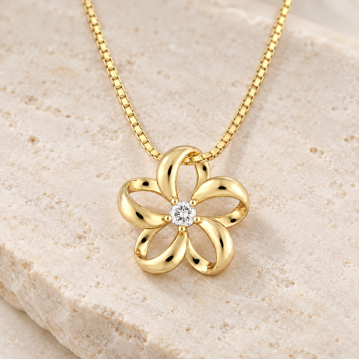 14K gold floating plumeria pendant with a diamond at the center