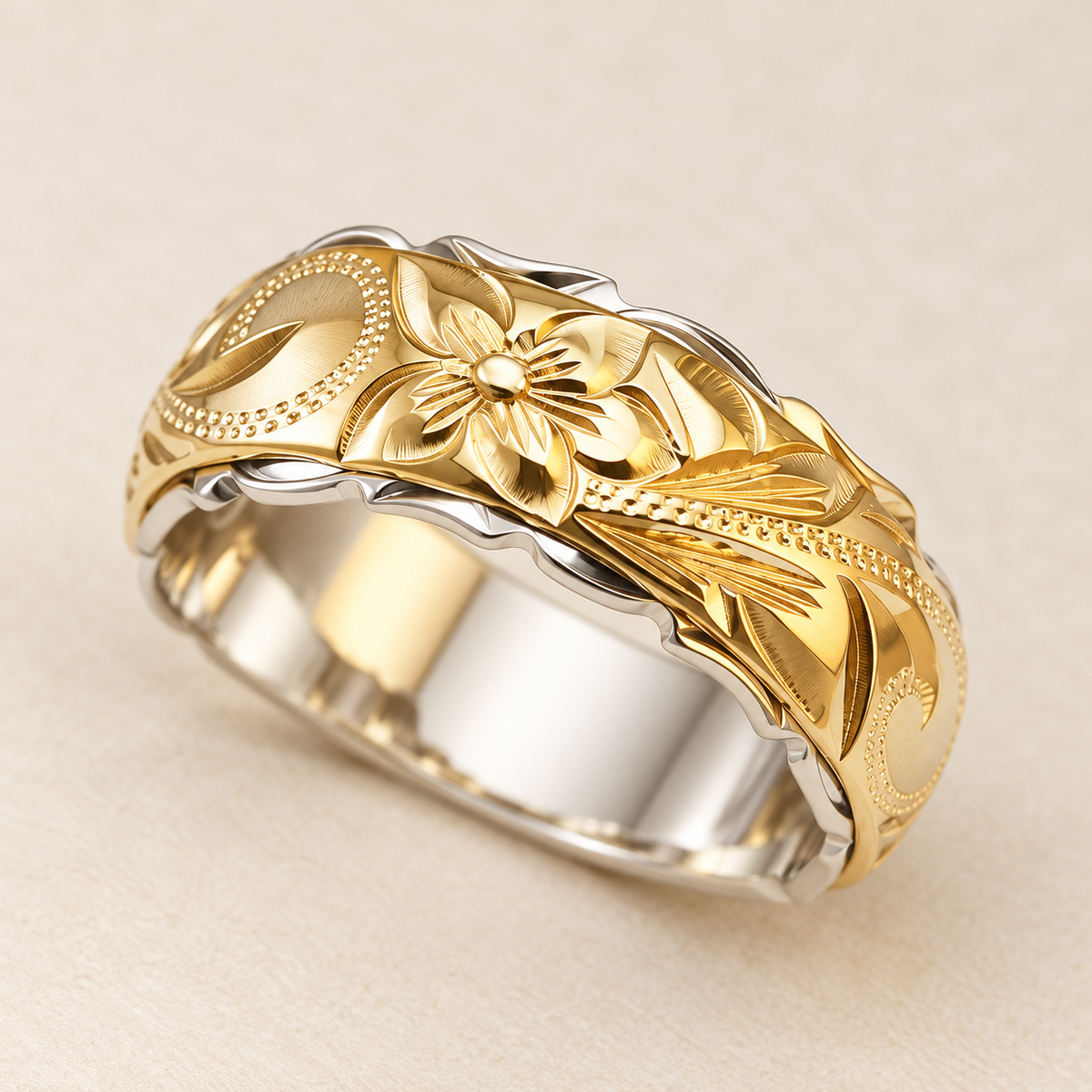 Yellow and white gold Hawaiian heritage ring showing the plumeria flower and scroll engraving on ivory.