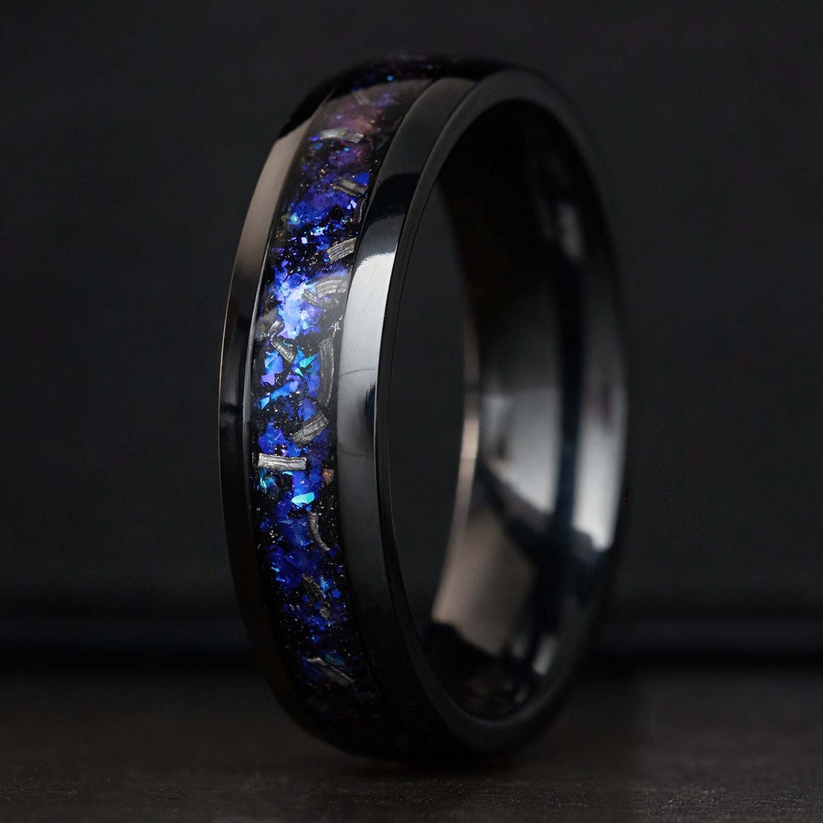 Black titanium ring with blue fire opal and meteorite inlay, angled view