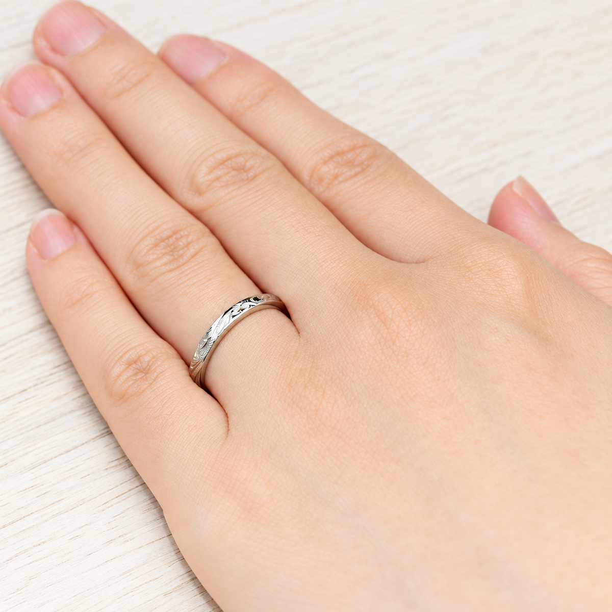 3mm hand engraved platinum Hawaiian Old English ring worn on a hand