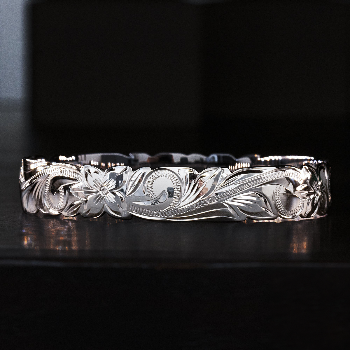 Sterling silver 10mm bangle with cutout wave edges and hand-engraved Hawaiian heritage design