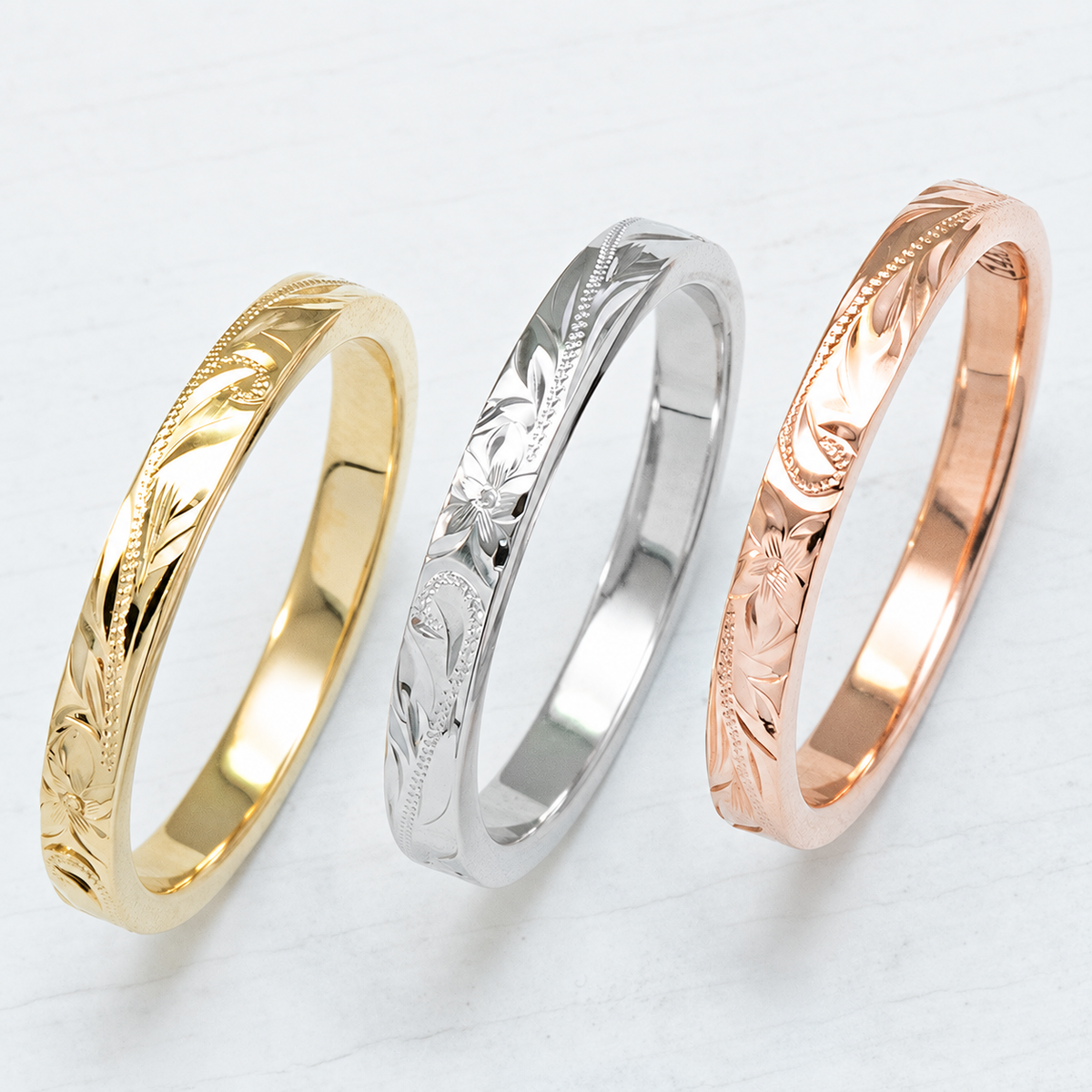 Slim Hawaiian engraved rings in yellow, white, and rose gold