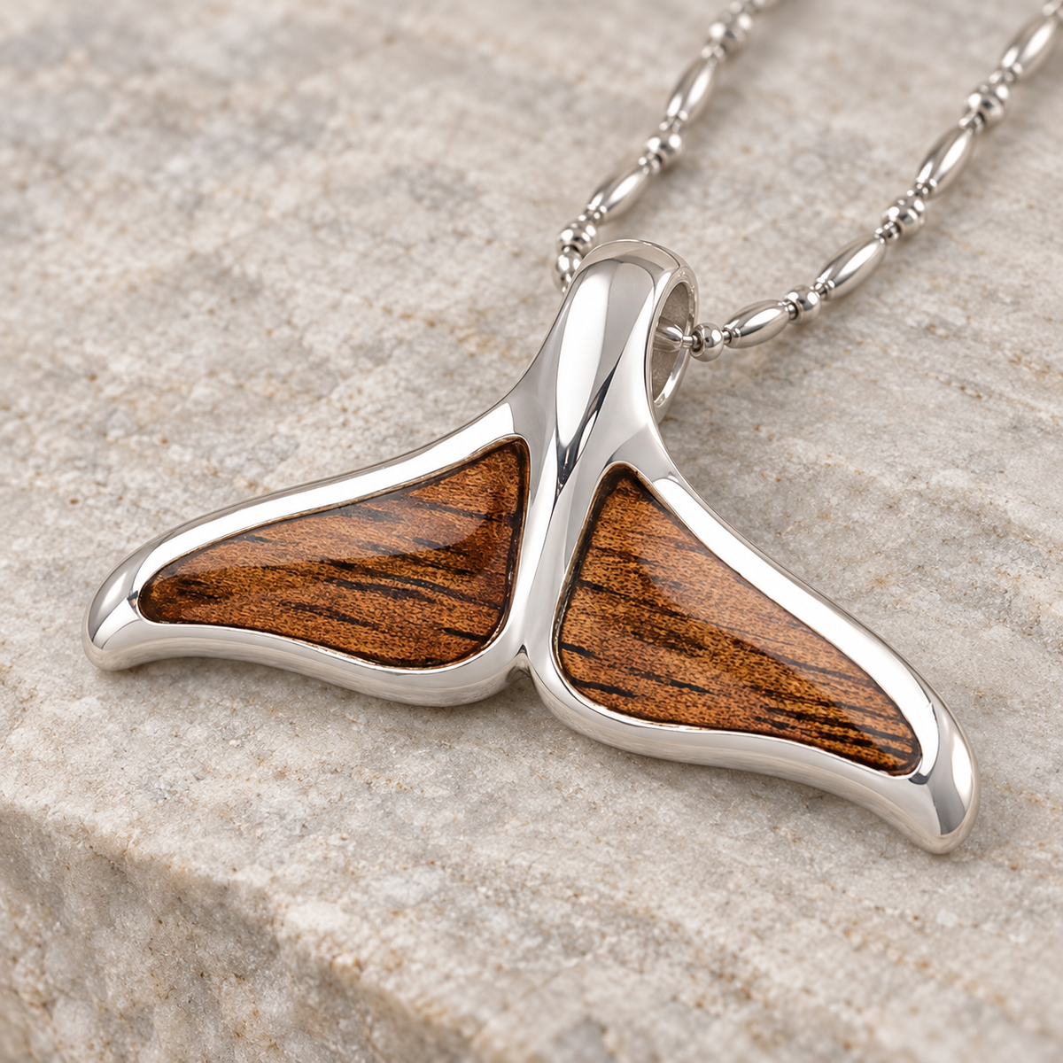 Sterling silver dolphin tail pendant with koa wood inlay, alternate angle
