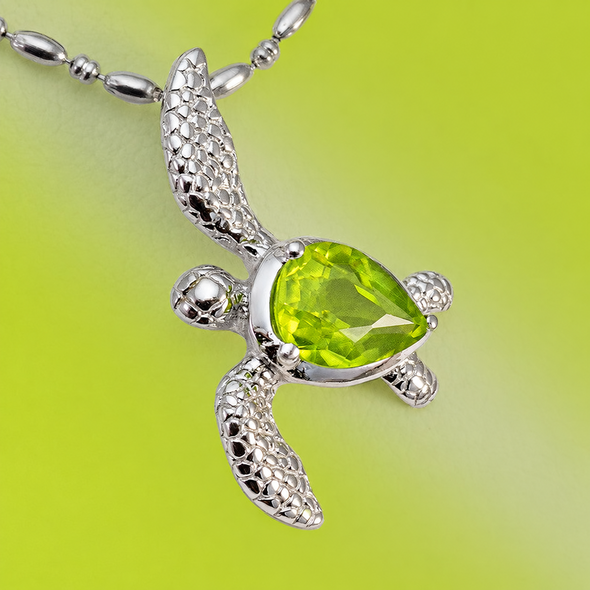 Sterling silver sea turtle pendant with pear-shaped peridot