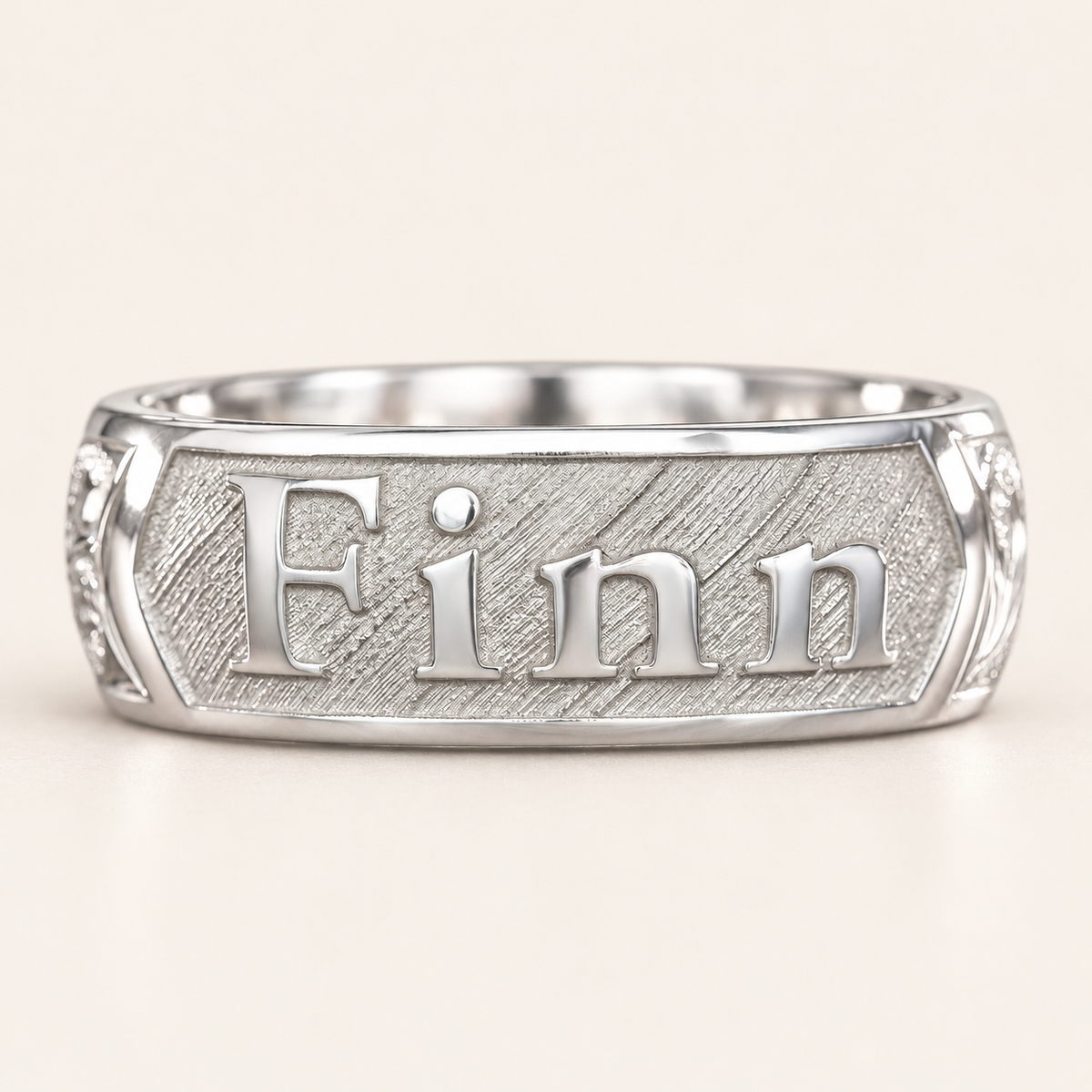 Front view of a sterling silver personalized name ring with raised Finn lettering on a textured silver panel.