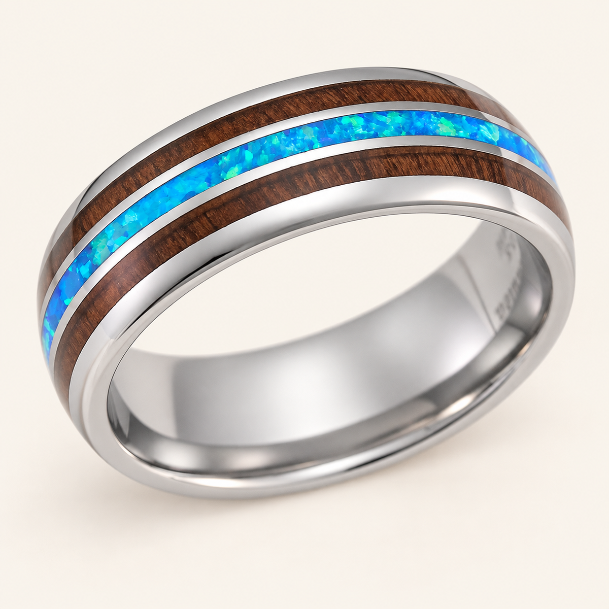 8mm tungsten carbide ring with koa wood and blue opal tri-inlay, close-up on an ivory background