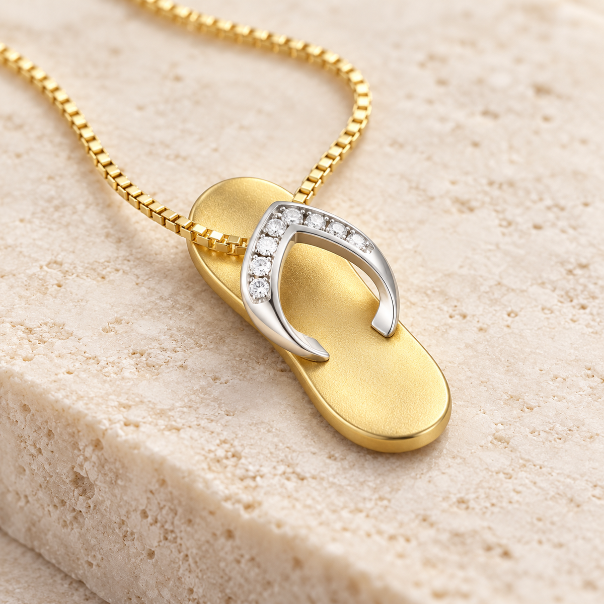 Two-tone gold slipper pendant with diamonds, angled view